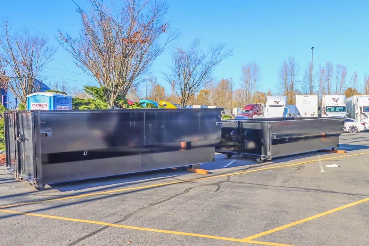 Professional dumpster rental service with roll-off container on residential driveway in Boynton Beach